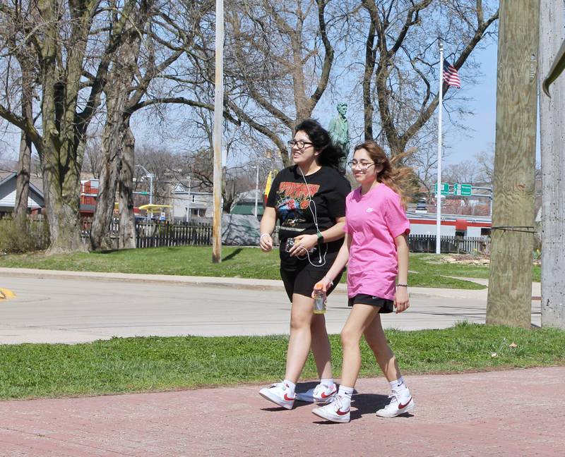 Ashleyn Zarate, 17, and Juli Vargas, 15, walk along the pedestrian and bicycle path near President's Park on Tuesday, April 11, 2023. Dixon was awarded a $2.25 million state grant for a bike path extension.