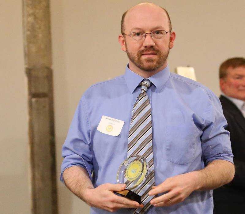 Derek Barichello, News Editor, Shaw Media poses for a photo with his award during the Illinois Valley Chamber of Commerce 40 Under Forty Awards Gala on Thursday, Feb. 9, 2023 at Westclox in Peru.