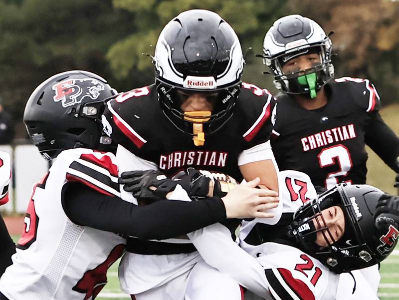 Erie-Prophetstown’s Panthers Kaleb Thompson (left) and Caleb Brown team up to stop Aurora Christian’s Jordan McGee Saturday, Nov. 1, 2025, at the IHSA 2A round one Playoff game hosted at Aurora Christian.