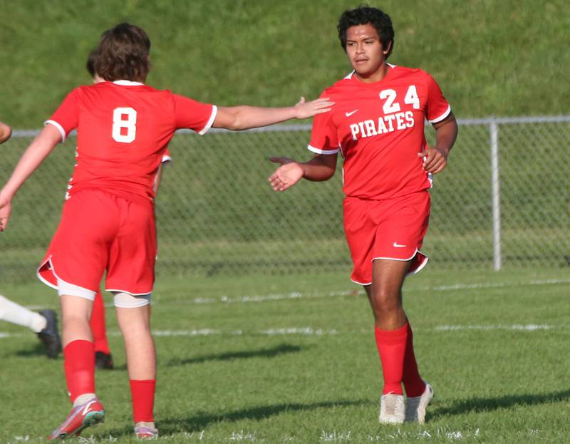 Ottawa's Luis Bedolla hi-fives teammate Mason Jaegle after scoring the teams first goal against Princeton on Tuesday, Oct. 3, 2023 at Ottawa High School.