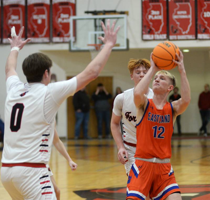 Eastland's Adam Awender (12) pulls up to shoot as Forreston's Brendan Greenfield (00) defends on Saturday, Jan. 4, 2025 at Forreston High School.