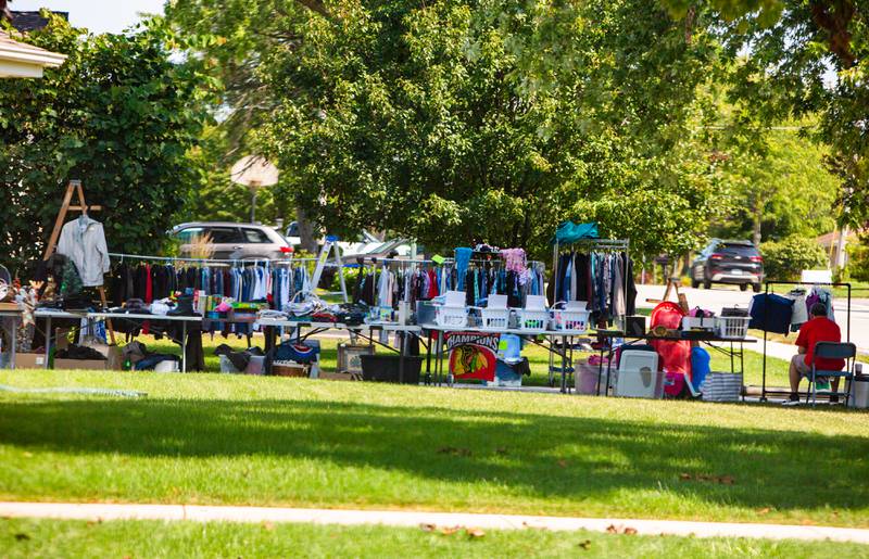 Clothing and household items line the driveway of a  Westmont home during the town’s weekend garage sales, Sunday, August 4, 2024.