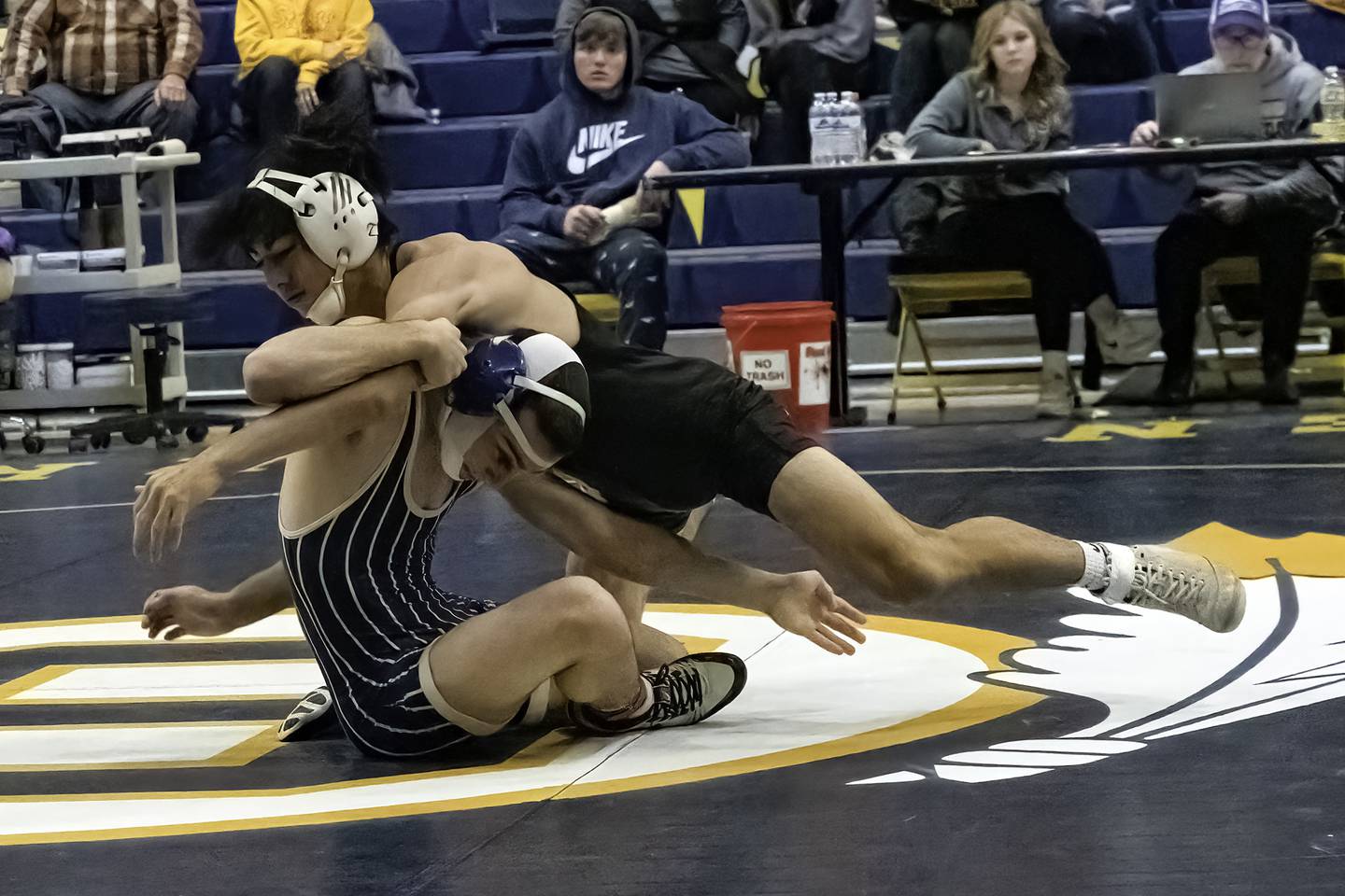 Newman's Carter Rude reaches for the leg of Dixon's Cade Hey during their 138-pound title bout at the 44th annual Carson DeJarnatt Tournament on Saturday, Dec. 3, 2022 at Musgrove Fieldhouse in Sterling.