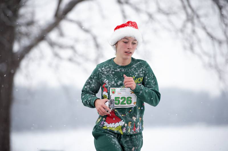 Sophie Venckauskas, a senior at Herscher High School, runs along the river at Kankakee Community College for the 35th annual Jingle Bell Run on Sunday, December 7, 2025.