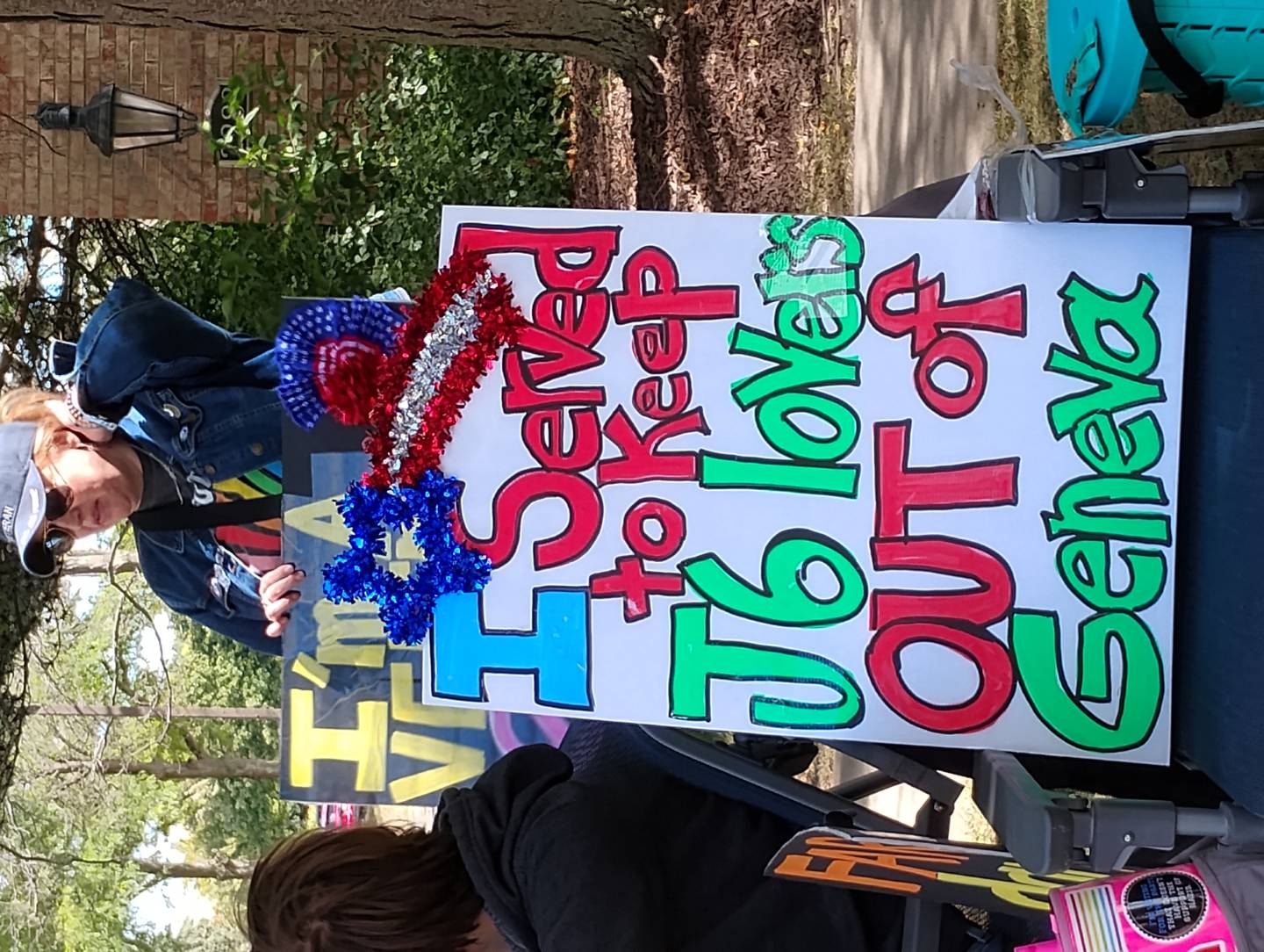 Jen Hall of Elburn protested in front of Eagle Brook Country Club in Geneva on Sunday, Sept. 7 against Elmer Stewart Rhodes III as a guest speaker there. Rhodes was convicted of seditious conspiracy and sentenced to 18 years in prison. President Trump commuted his sentence in January. Rhodes did not speak in Geneva, but was welcomed to a church in Elgin.