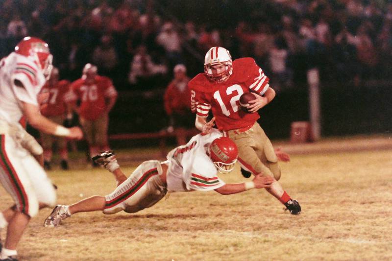 Ottawa quarterback Kyle Windy fights his way out of a tackle from a La Salle-Peru player on Friday, Oct. 23, 1992 at King Field in Ottawa.