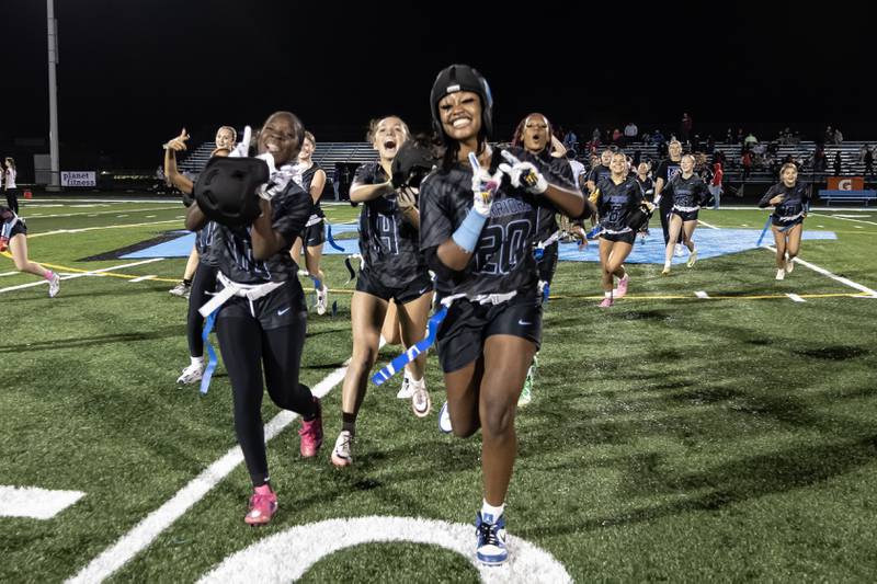 Willowbrook’s varsity flag football team celebrates after winning an IHSA State Quarterfinals game against Kenwood, held at Willowbrook High School on Oct. 17.