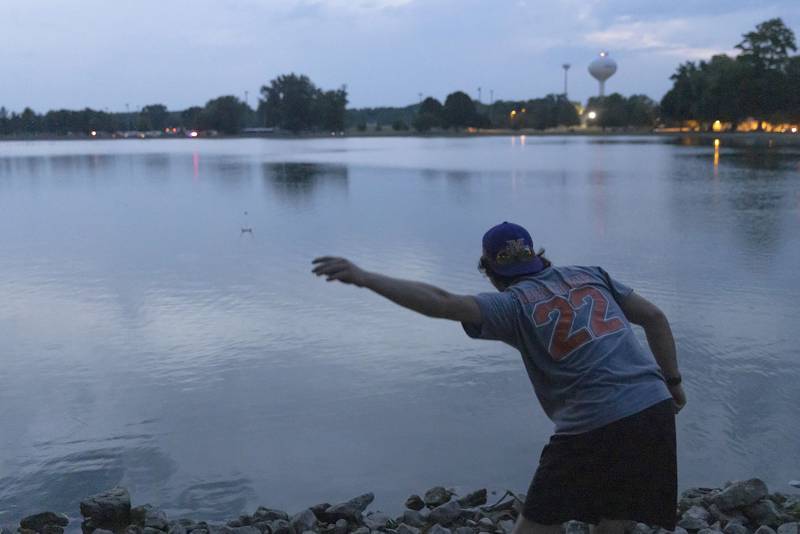 Ted Landgraf skips a stone while awaiting the start of the Mendota fireworks on Saturday, June 24, 2023 at Lake Mendota.