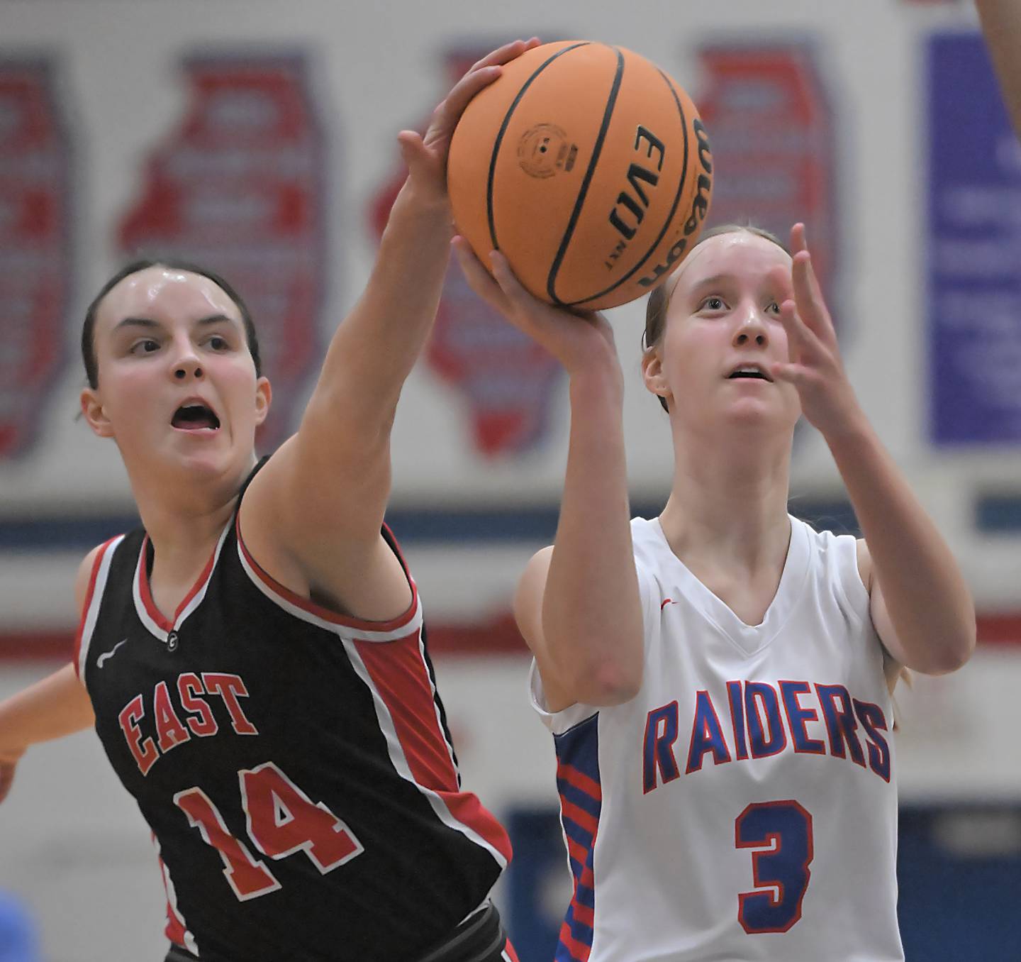 Glenbard South’s Jamie Mizwicki shoots as Glenbard East’s Teagan Murphy tries to block her shot in a girls basketball game in Glen Ellyn on Friday, Feb. 7, 2024.