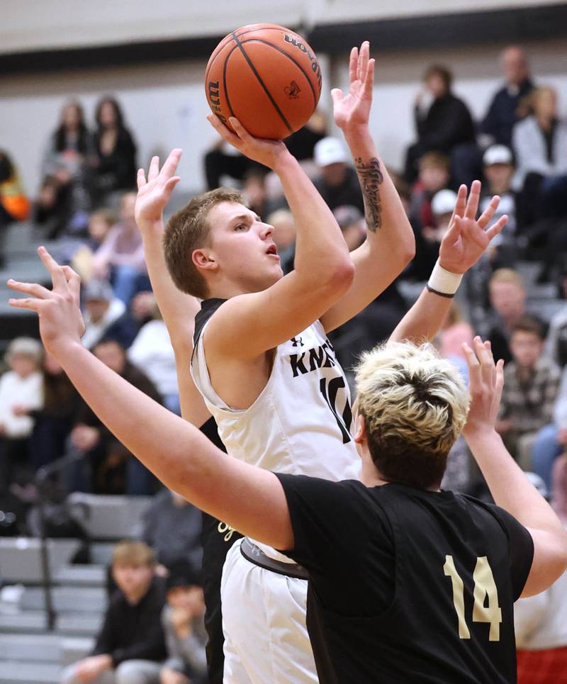 Kaneland's Troyer Carlson shoots over Sycamore's Michael Chami during their game Friday, Jan. 5, 2024, at Kaneland High School in Maple Park.