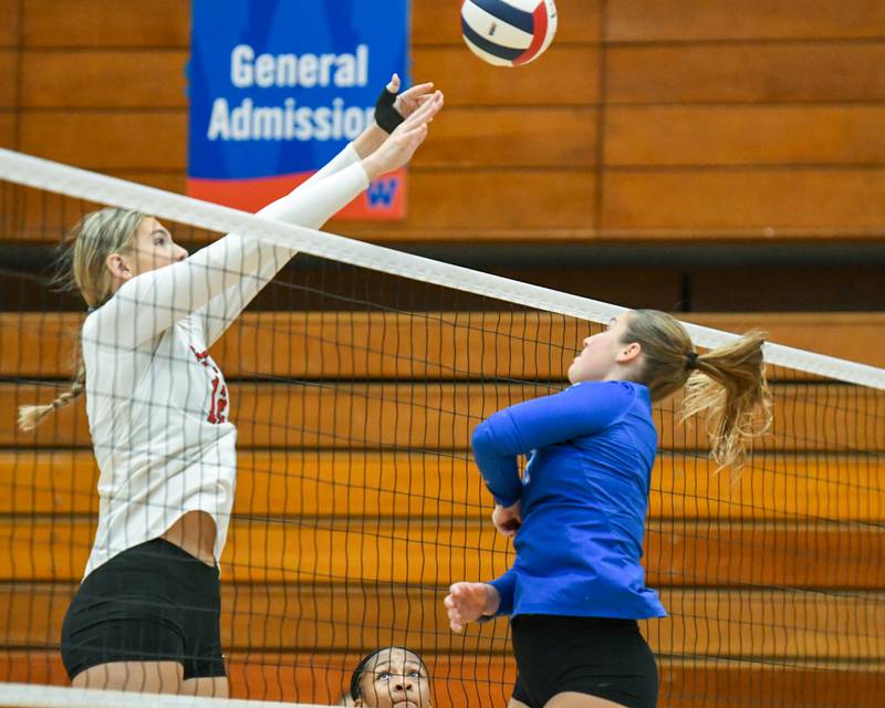 Benet Academy's Lynney Tarnow (12) tries to block the ball from St. Charles North's Mia McCall (7) during the first game of two of the 4A sectional finals game on Thursday Nov. 7, 2024, held at West Aurora High School