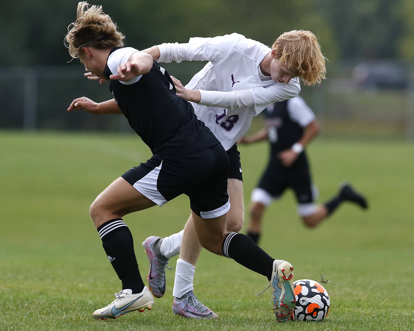 Hampshire's Jackson Carey pushes Prairie Ridge's Gabriel Porter off the ball during a Fox Valley Conference soccer match Tuesday, Sept. 19, 2023, at Prairie Ridge High School in Crystal Lake.