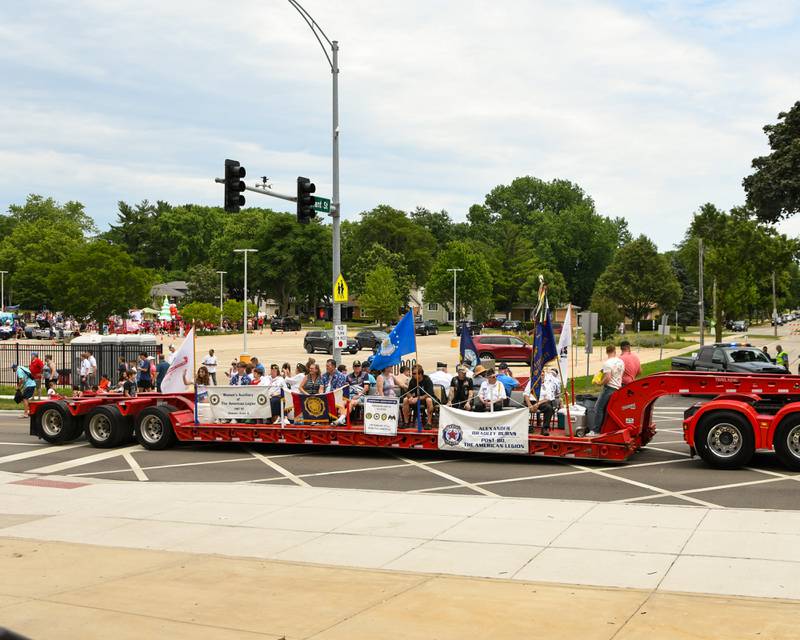 Members of the Woman’s Auxiliary of The American Legion in Downer Grove ride on a flatbed trailer during the Independence Day parade on Friday July 4, 2025, that went down Main Street in Downers Grove.