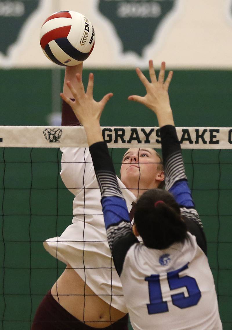 Prairie Ridge's Adeline Grider hits the ball over the block of St. Francis' Delaney Zamis during the IHSA Class 3A Grayslake Central Supersectional volleyball match on Monday, Nov. 11, 2024, at Grayslake Central High School.