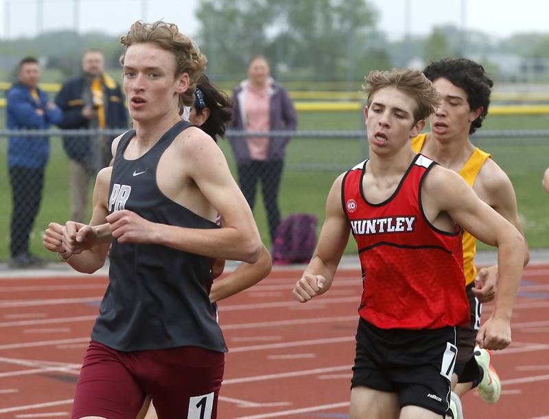 Prairie Ridge’s Will Gelon and Huntley’s Tommy Nitz run in the 3200 meter run during the IHSA Class 3A Huntley Boys Track and Field Sectional Wednesday, May 18, 2022, at Huntley High School.
