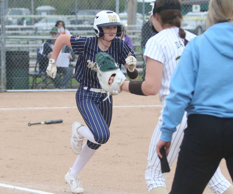 Marquette's Hunter Hopkins reaches first base as St. Bede's Maddy Dalton looks for the late throw on Thursday, April 18, 2024 in Ottawa.