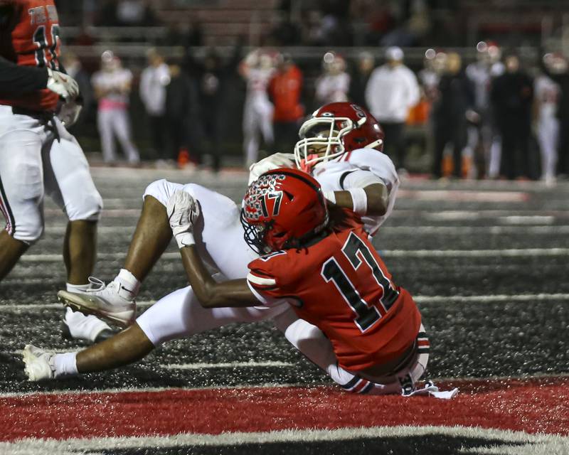 Yorkville's T.J. Harland (5) lands into the endzone during football game between Yorkville at Bolingbrook Friday, Oct 24, 2025 in Bolingbrook.