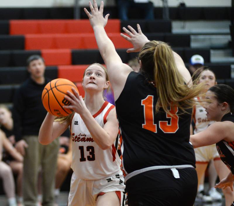 Fulton's Hailey Smither (13) gets ready to shoot as Milledgeville's Olivia Wooden (14) defends during a Friday, Jan. 24, 2025 game at Fulton High School.