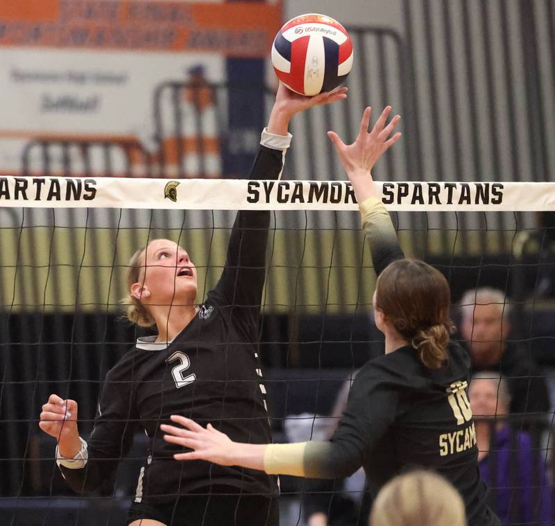 Kaneland's Audrey Peters tries to tip the ball over Sycamore's Sophia Martinez during their match Tuesday, Oct. 1, 2024, at Sycamore High School.