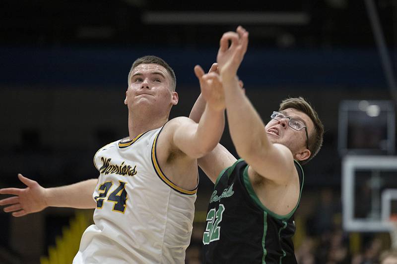 Sterling’s Lucas Austin and Rock Falls’ Chevy Bates work below the basket Tuesday, Nov. 29, 2022.
