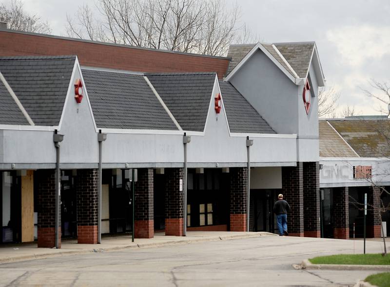 A man walks to one of the few businesses in the Crystal Court shopping center at 6000 Northwest Highway in Crystal Lake on Wednesday, April 13, 2022.