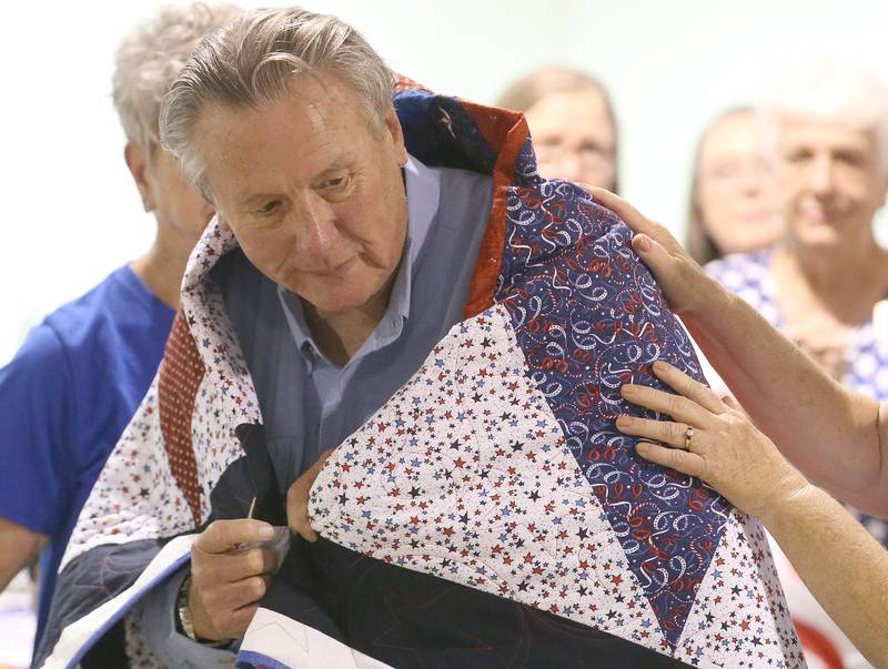 U.S. Army Veteran Dr. Gerald Levisay of Spring Valley, receives his Quilt of Valor during the Tribute to Veterans on Wednesday, Aug. 20, 2025 at the Bureau County Fair in Princeton.