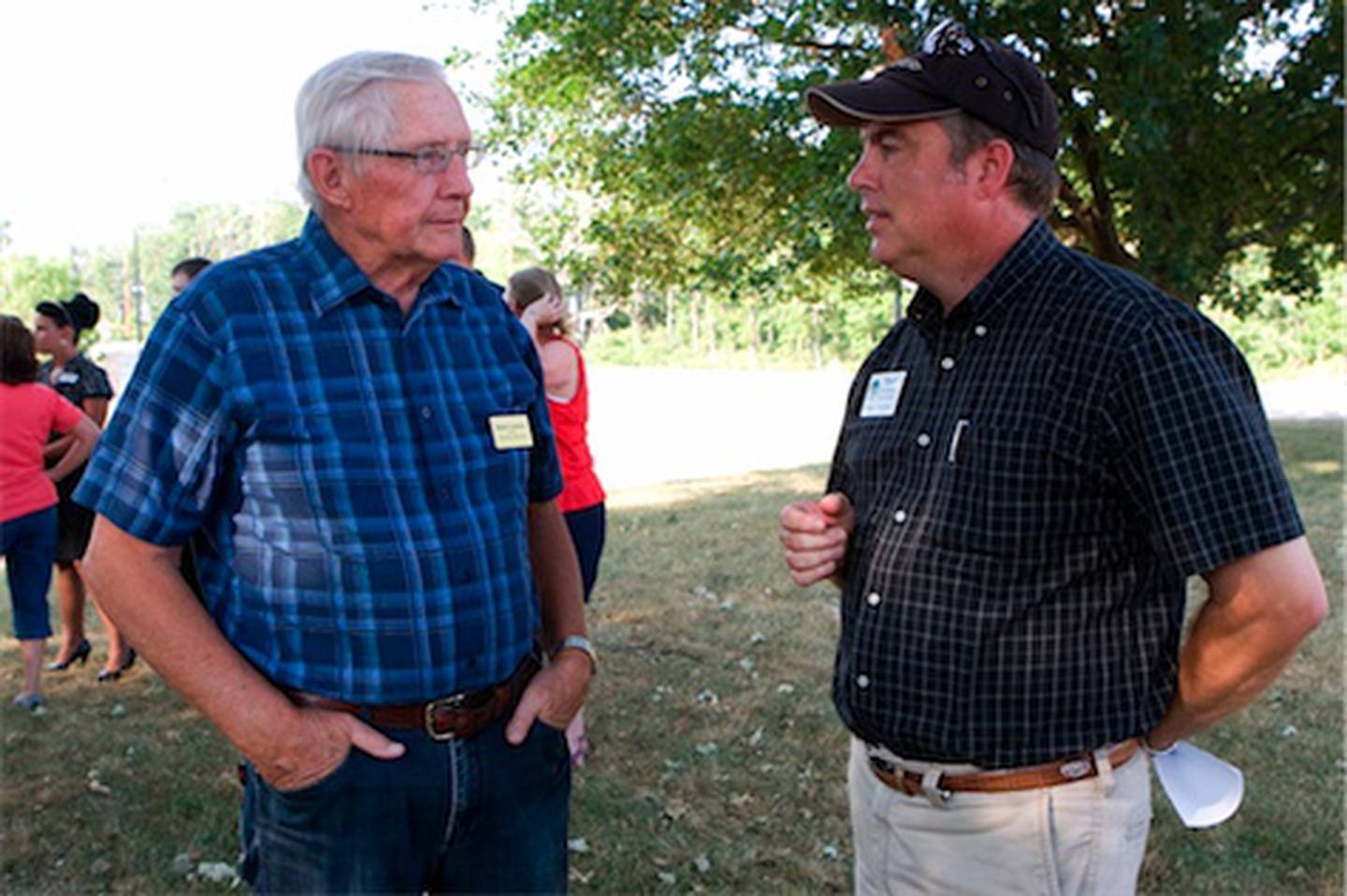 Village of Huntley Trustee Harry Leopold (left) speaks with Thom Palmer, Executive Director of the Huntley Park District, during a celebration held by the Huntley Area Chamber of Commerce to mark the widening of Route 47 Tuesday, July 17, 2012 at Deicke Park in Huntley.