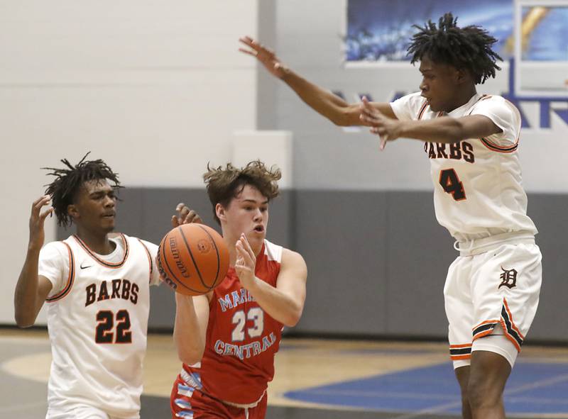 Marian Central's Cale McThenia passes out of a double-team by DeKalb's Darell Island and Johnny Henderson during a Central High School’s Dr. Martin Luther King, Jr., Boys Basketball Tournament game Friday, Jan. 13, 2023, at Central High School in Burlington.