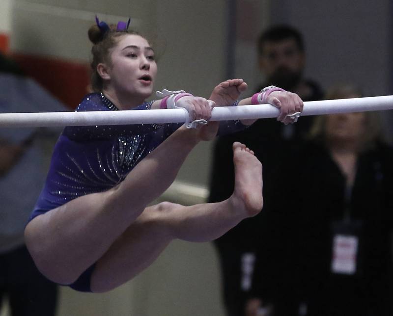 Downers Grove's Edith Condon competes on the uneven parallel bars during the IHSA Girls State Gymnastics Meet at Palatine High School on Saturday, Feb. 17, 2024.
