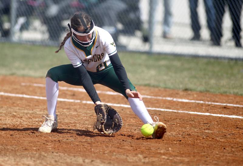 Waubonsie Valley first baseman Gia Cobert scoops up a ground ball during a home game against Oswego East on Friday, April 1, 2022.