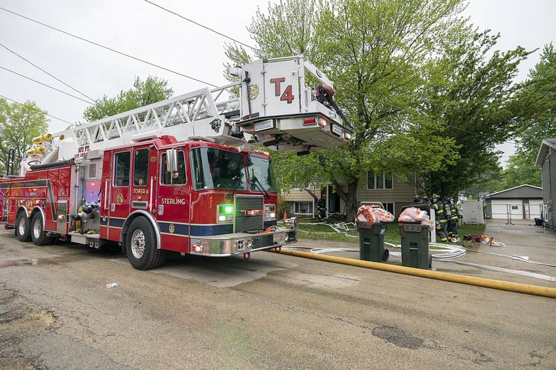 Firefighters work at the scene of a fire in the 800 block of Avenue I in Sterling on Monday, April 27, 2026.
