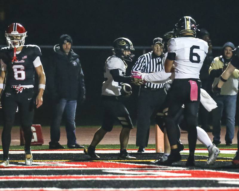 Glenbard North's Donato Gatses (22) is greeted after scoring a touchdown during Class 7A first round football game between Glenbard North at Yorkville. Friday, Oct 31, 2025 in Yorkville.