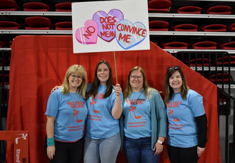 Participants pose for a photo at Safe Passage's annual Walk A Mile in Their Shoes event on April 18, 2026, at the Northern Illinois University Convocation Center in DeKalb. The event, held to raise awareness of sexual violence and supoprt survivors, was hosted by the nonprofit as part of Sexual Assault Awareness Month.