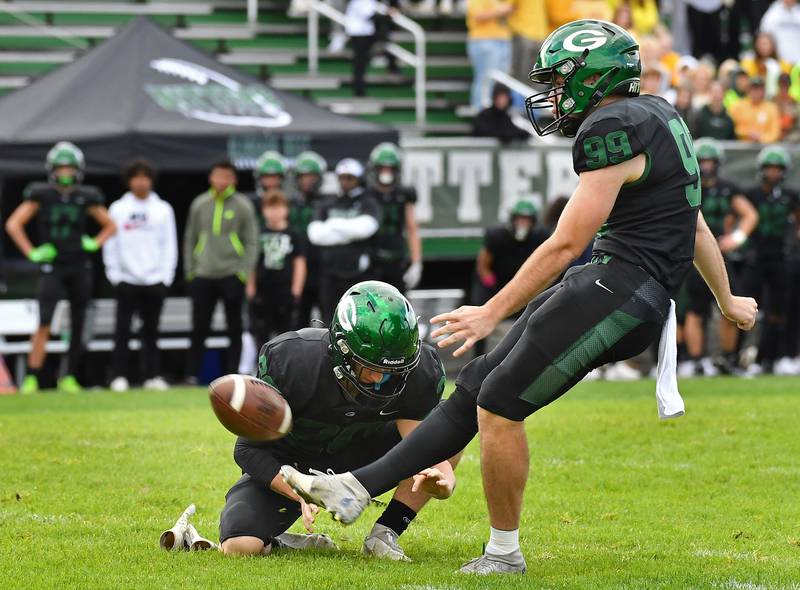 Glenbard West's Aidan Nelson (99) kicks a filed goal out of the hold of Joey Campanella during an IHSA Class 8A playoff game against Naperville North on Oct. 28, 2023 at Glenbard West High School in Glen Ellyn.