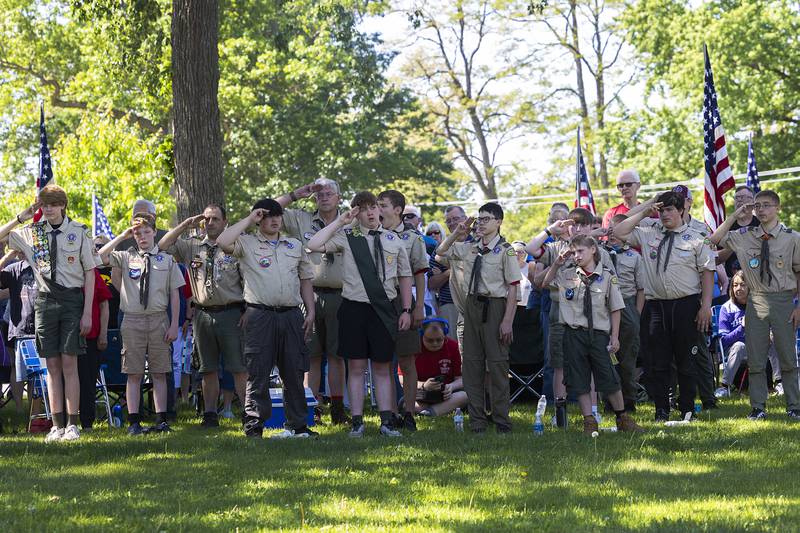 Scouts salute in respect Monday, May 25, 2026, as taps is played for Memorial Day at Oakwood Cemetery.