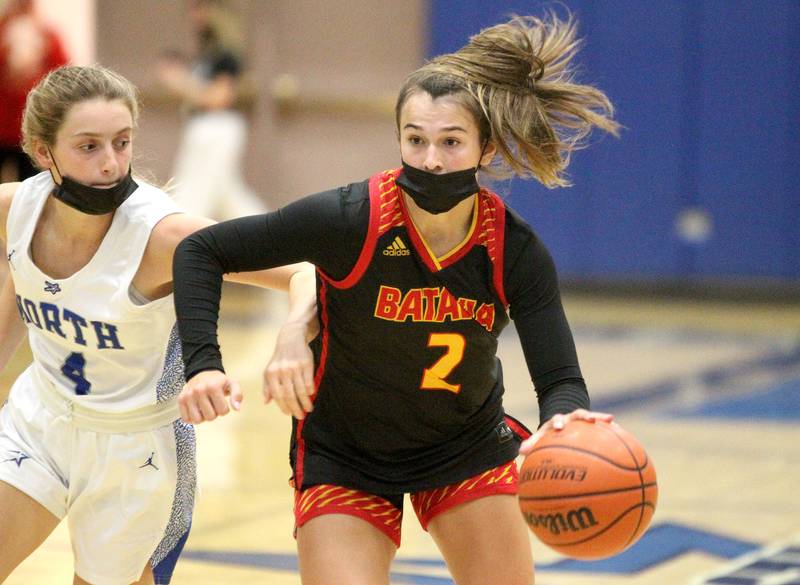 Batavia's Brooke Carlson (2) keeps the ball away from St. Charles North's Julia Larson during a game at St. Charles North on Thursday, Jan. 13, 2022.