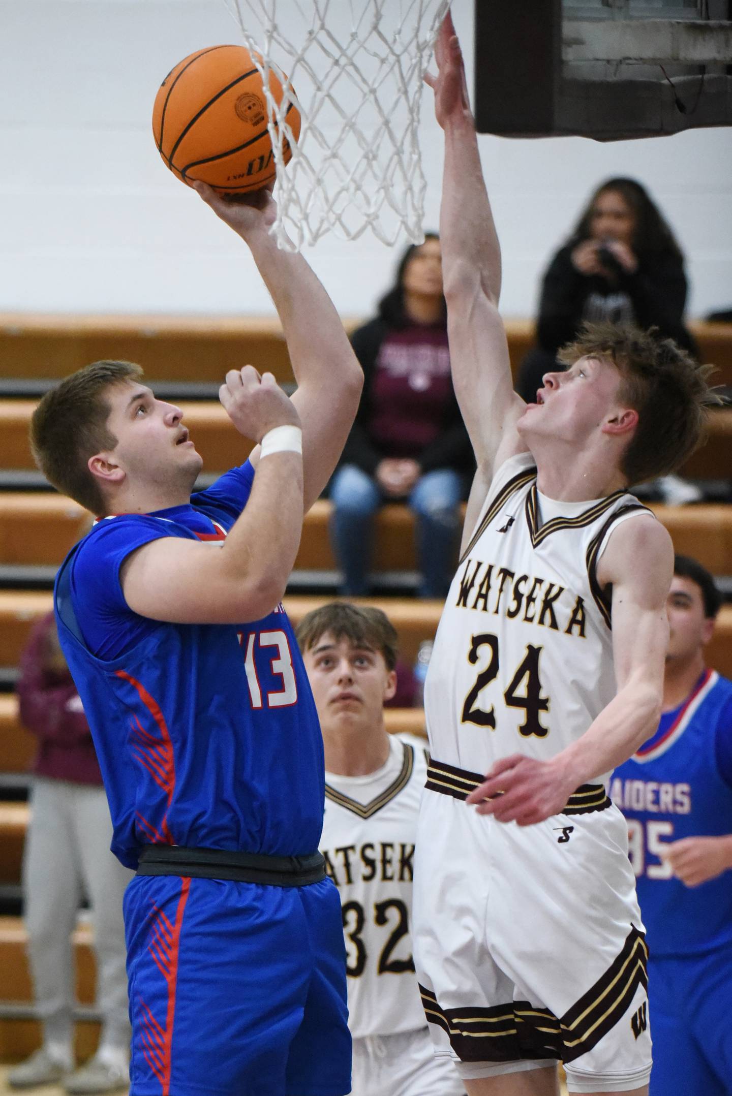 Iroquois West's Cort Leonard, left, puts back an offensive rebound as Watseka's James Newell defends during the IHSA Class 2A Hoopeston Regional quarterfinals at Watseka Monday, Feb. 24, 2025.