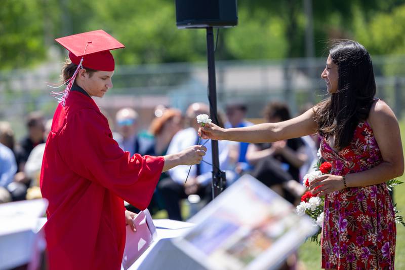 Lukas Manriquez receives flower on Sunday, May 18, 2025 at Hall High School in Spring Valley.