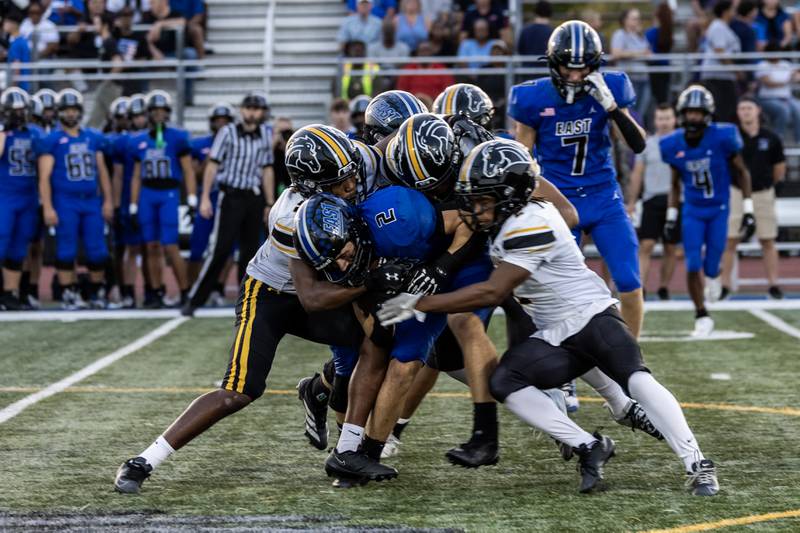Lincoln-Way East's Brody Gish gets tackled by the Metea Valley defense during a varsity football game at Lincoln-Way East on Oct. 3, 2025.