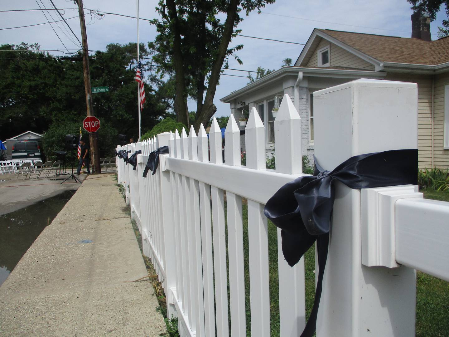 Black ribbons tied along the white picket fence posts at Jose Duenez Jr.'s boyhood home in Joliet serve to mourn his death in an Army training exercise in March in Lithuania. July 11, 2025