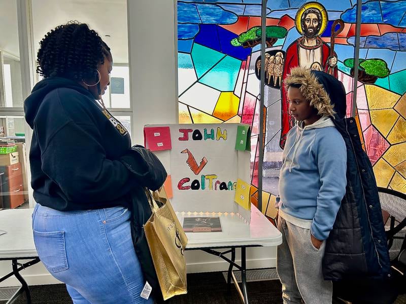 Braxton Beck (right) shares his work about jazz musician and composer John Coltrane  on Sunday, Feb. 16, 2025, at New Hope Missionary Baptist Church in DeKalb. The presentation was part of the church's annual Black History Month event "Displays of Excellence.”