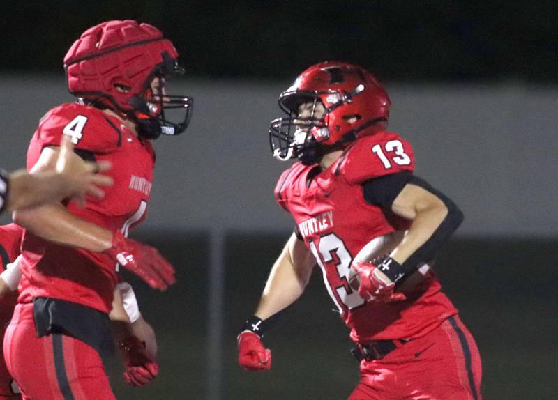 Huntley’s Kyle Ziebell, right, celebrates with Connor Wade, left, after Ziebell’s second touchdown reception of the night against Cary-Grove in varsity football at Huntley High School in Huntley on Friday, Sept. 19, 2025.