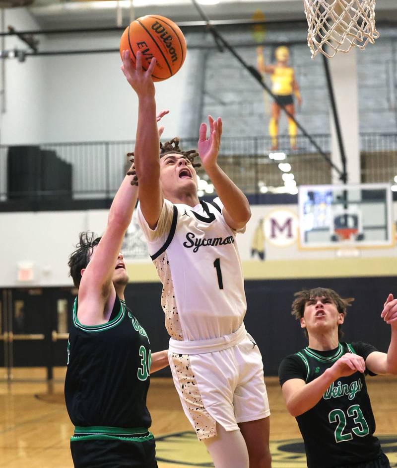Sycamore's Josiah Mitchell gets a layup in front of North Boone's Ronnie Ragland during their game Tuesday, Dec. 3, 2024, at Sycamore High School.