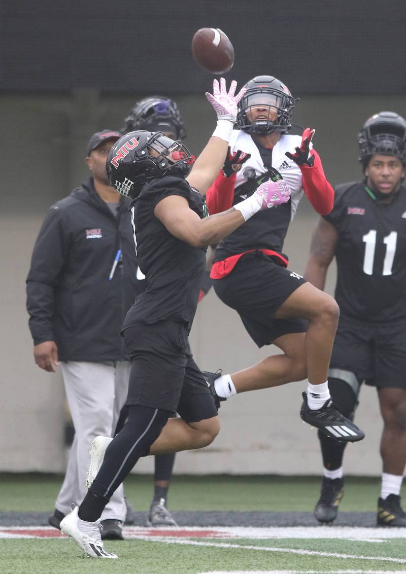 Northern Illinois University receiver Isaiah Bragg makes a catch over NIU cornerback Jeremiah Howard during spring practice Wednesday, March 23, 2022, in Huskie Stadium at NIU in DeKalb.