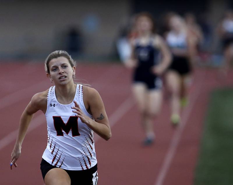 McHenry’s Alyssa Moore cruise to victory in the 800 meter run Friday, May 5, 2023, during the Fox Valley Conference Girls Track and Field Meet at Huntley High School.