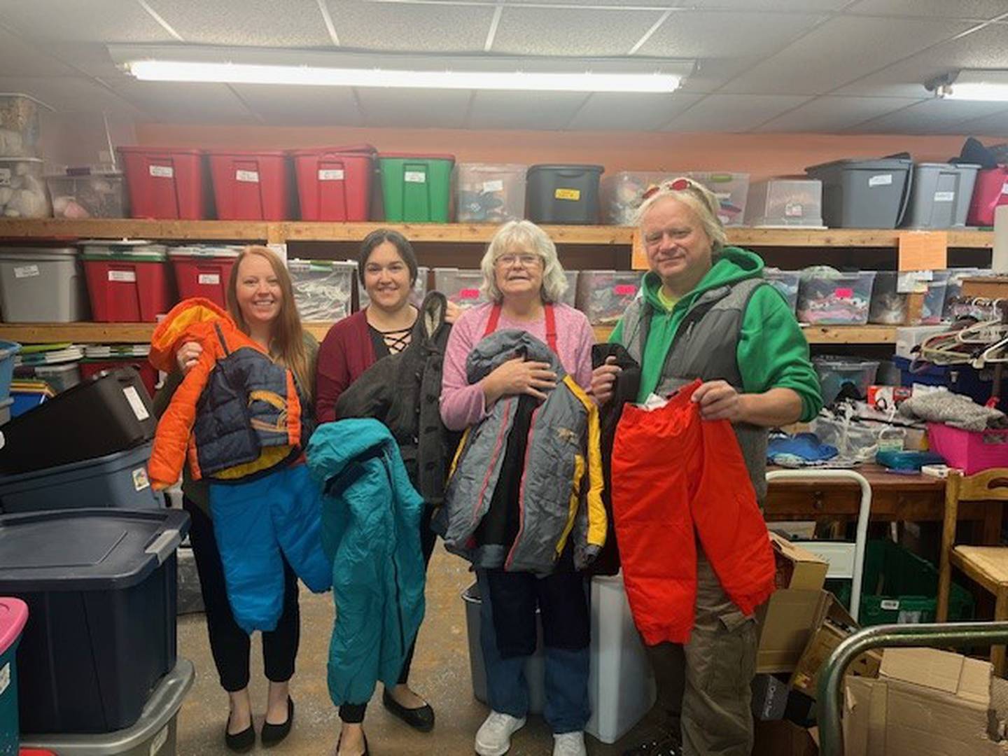 Representatives from Our Caring Closet in Wilmington accept the donation of coats from Grundy Bank.
