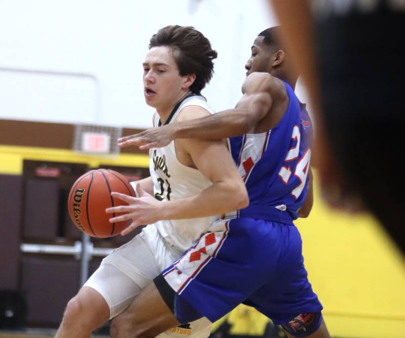 Crystal Lake South’s Cooper LePage moves the ball against Hoffman Estates’ Kentrell Branch during Hinkle Holiday Classic Basketball Tournament action at Jacobs High School Thursday.