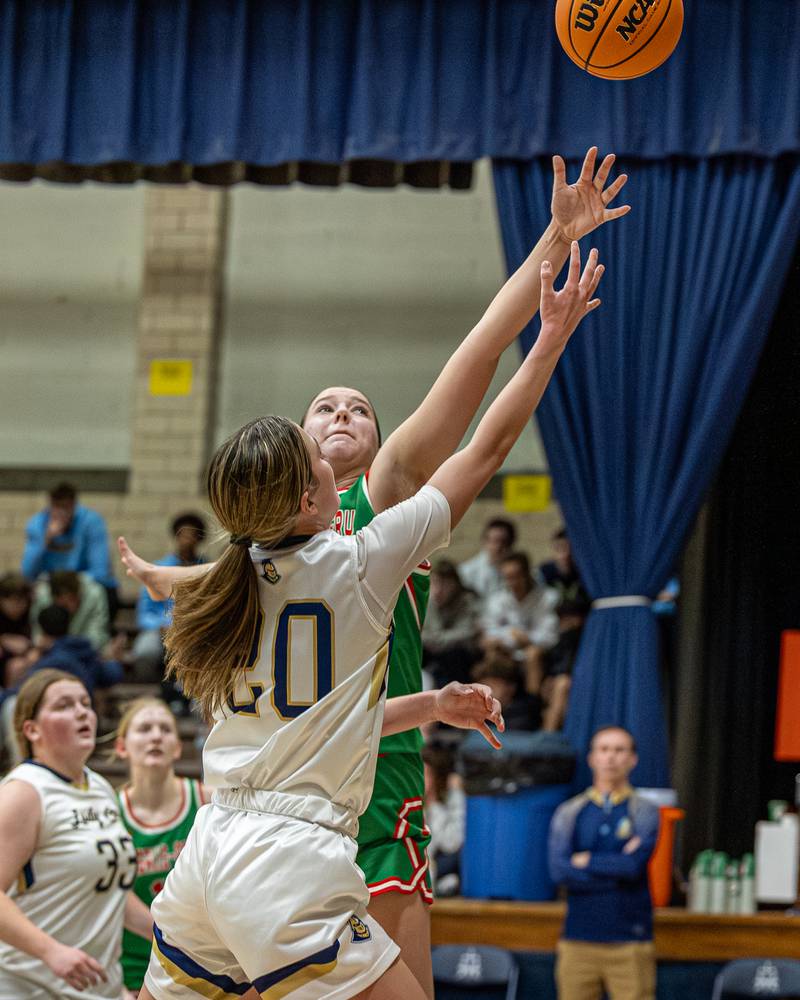 Kaitlyn Davis (20) of Marquette lays up ball as Brianna Ruppert (22) of LaSalle-Peru attempts to block shot on Saturday, January 3, 2026 at Marquette Academy in Ottawa.