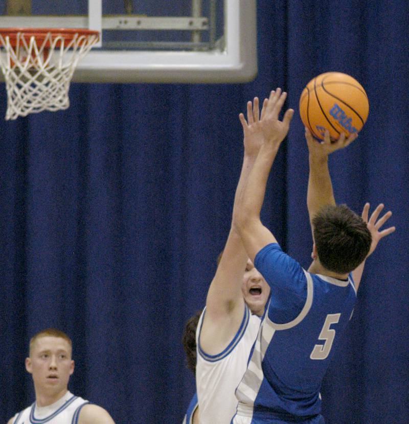 Princeton's Jack Oester goes for a shot over a Newman defender. 1-3 Princeton played Newman (3-0) in a conference game. The matchup took place at Newman High School on Friday, December 5, 2025.