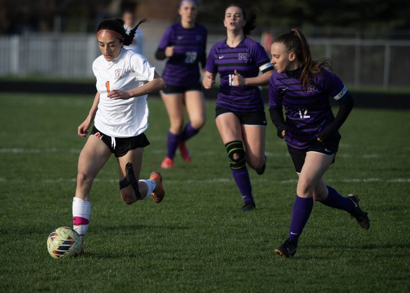 Beecher's Grace Durante, left, controls the ball as Manteno's Kaylee Boudreau, right, follows during Monday's game in Manteno.